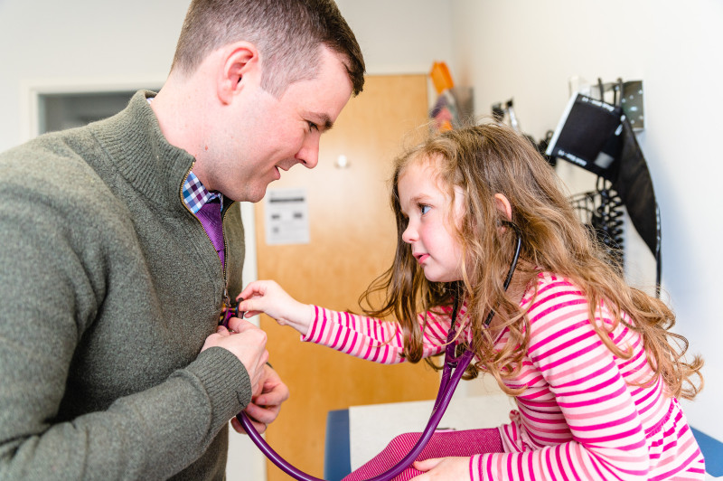 a girl listening to the heart of her pediatrician