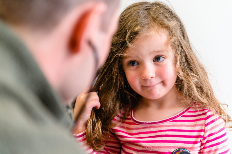 a girl looking up at her doctor