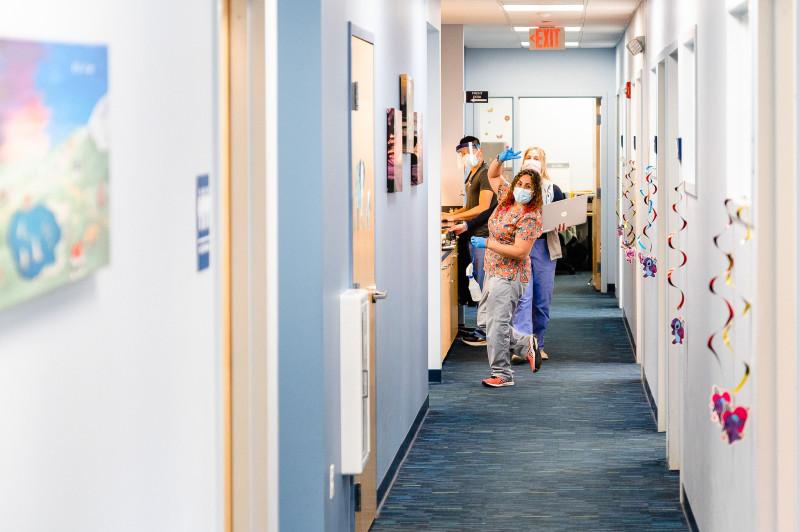 a group of people at the end of a hallway